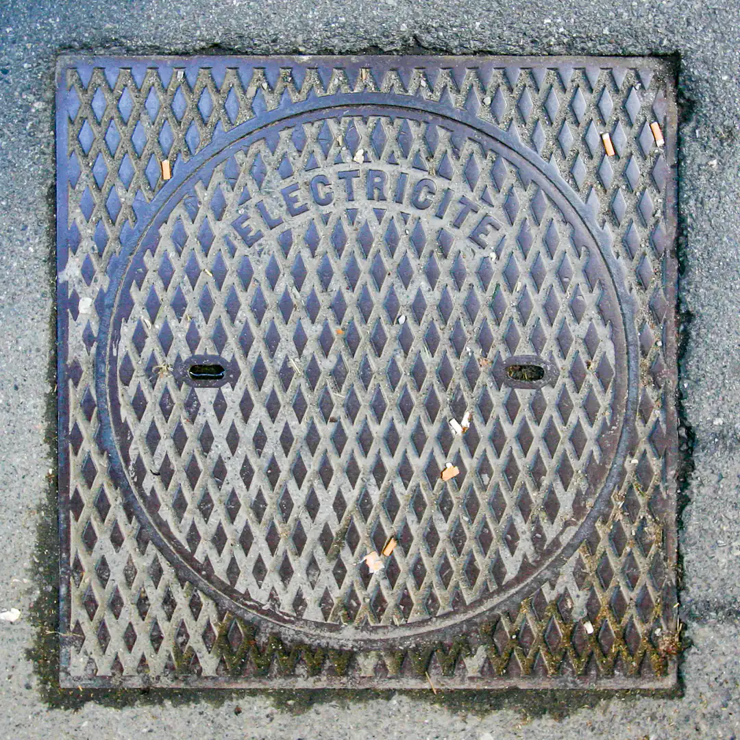 Electricity Manhole Cover in Geneva, Switzerland. Photo by Yuri Matrosovich