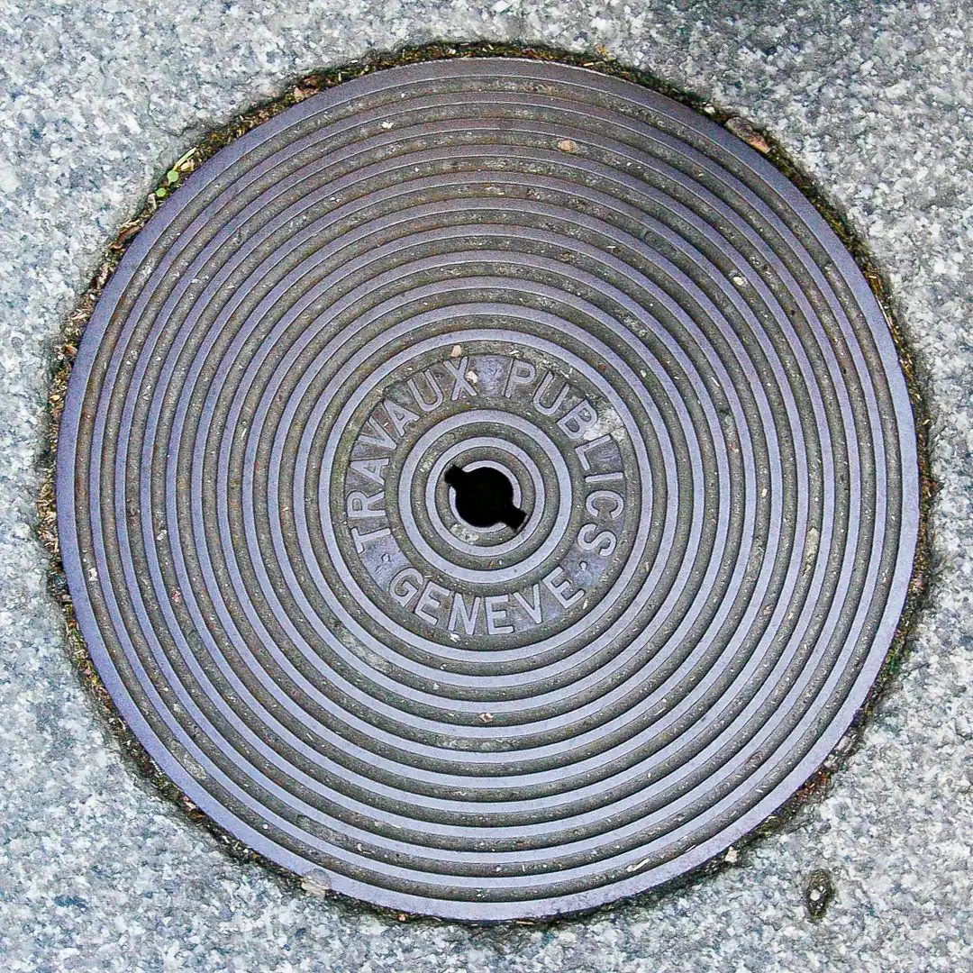 Manhole Cover in Geneva, Switzerland. Photo by Yuri Matrosovich