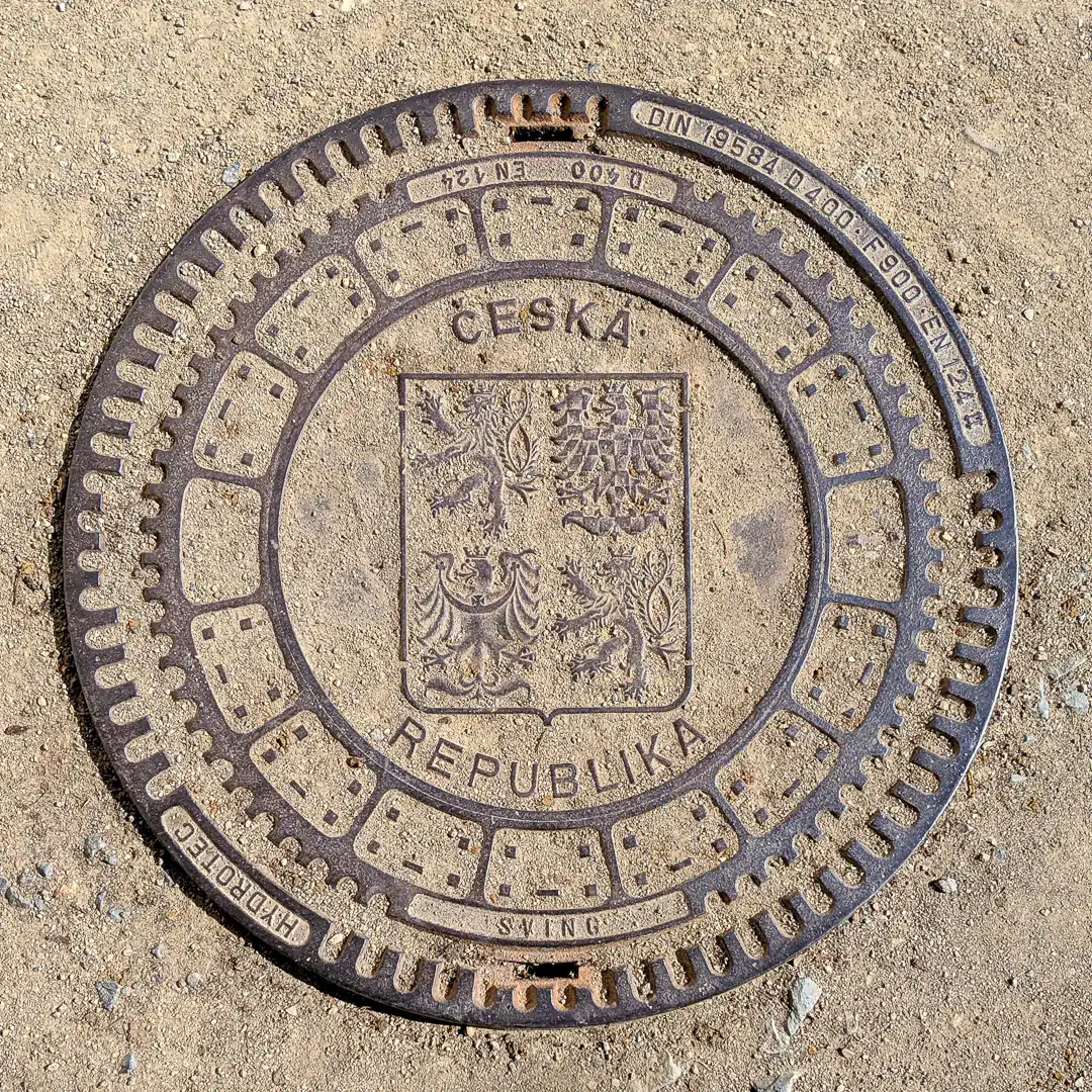 Manhole Cover with Coat of Arms of the Czech Republic in Prague, Czech Republic. Photo by Yuri Matrosovich