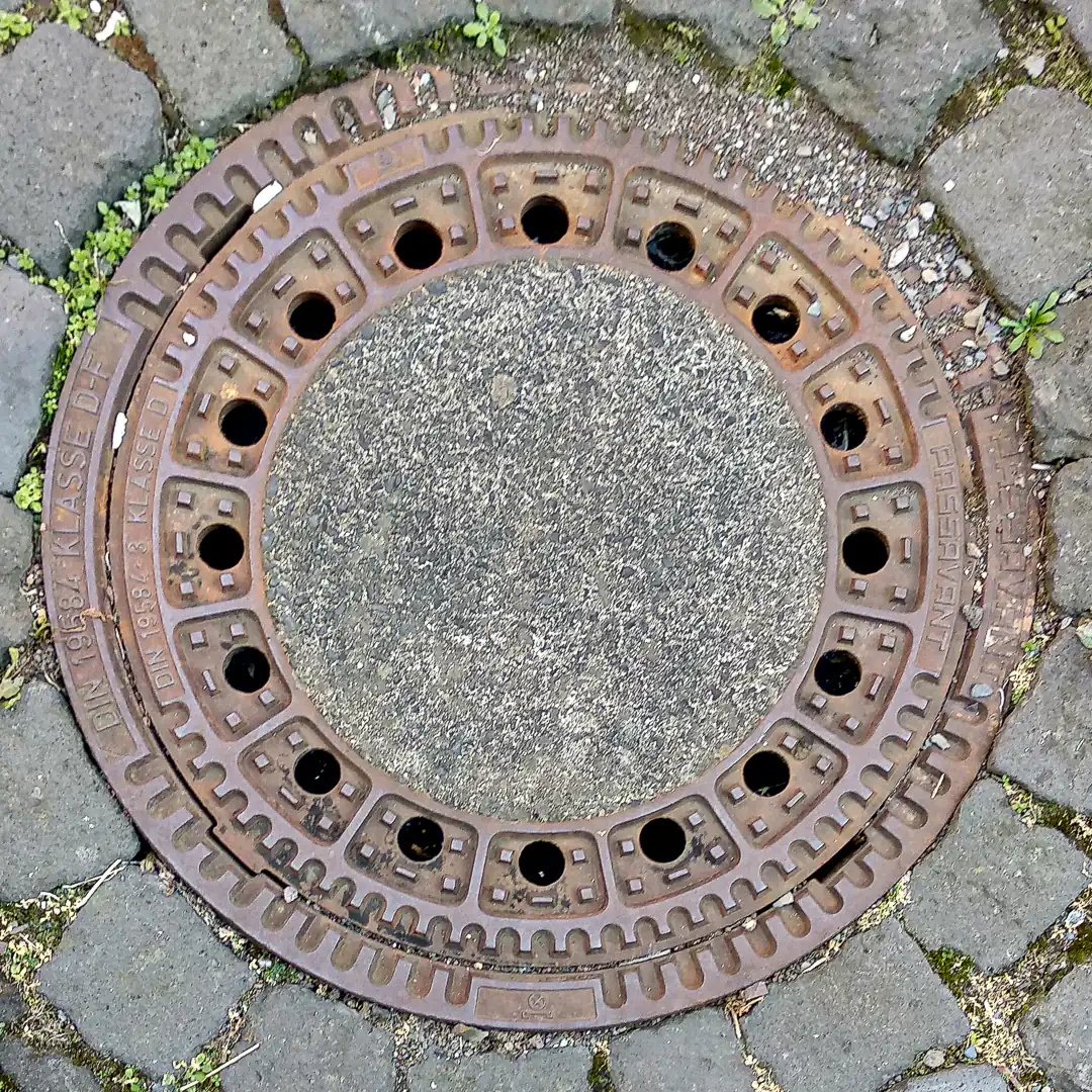 Concrete Manhole Cover with Metal Frame in Cochem, Germany. Photo by Yuri Matrosovich