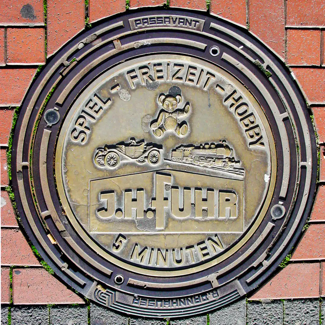 J. H. Fuhr Ad on Manhole Cover in Gießen, Germany. Photo by Yuri Matrosovich