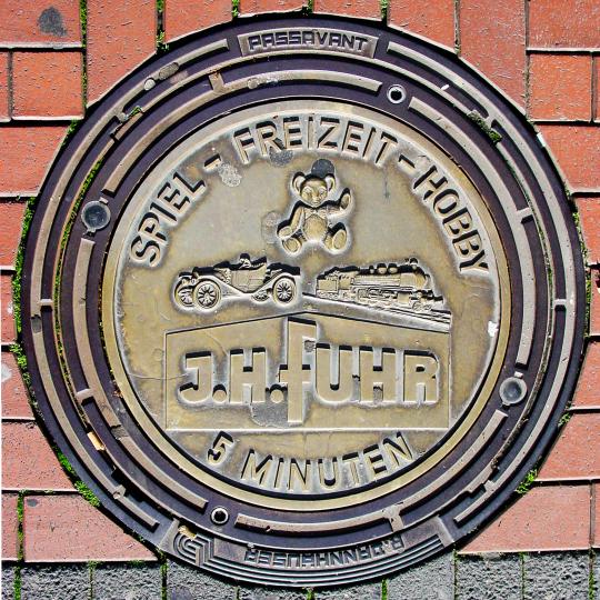 J. H. Fuhr Ad on Manhole Cover
