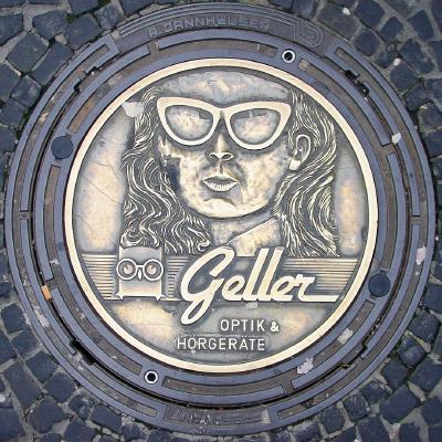 Geller Optik Ad on Mahole Cover