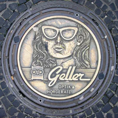 Geller Optik Ad on Mahole Cover