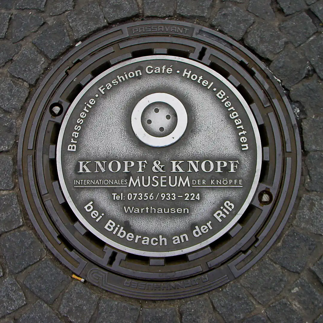 Knopf & Knopf Museum Ad Manhole Cover in Würzburg, Germany. Photo by Yuri Matrosovich