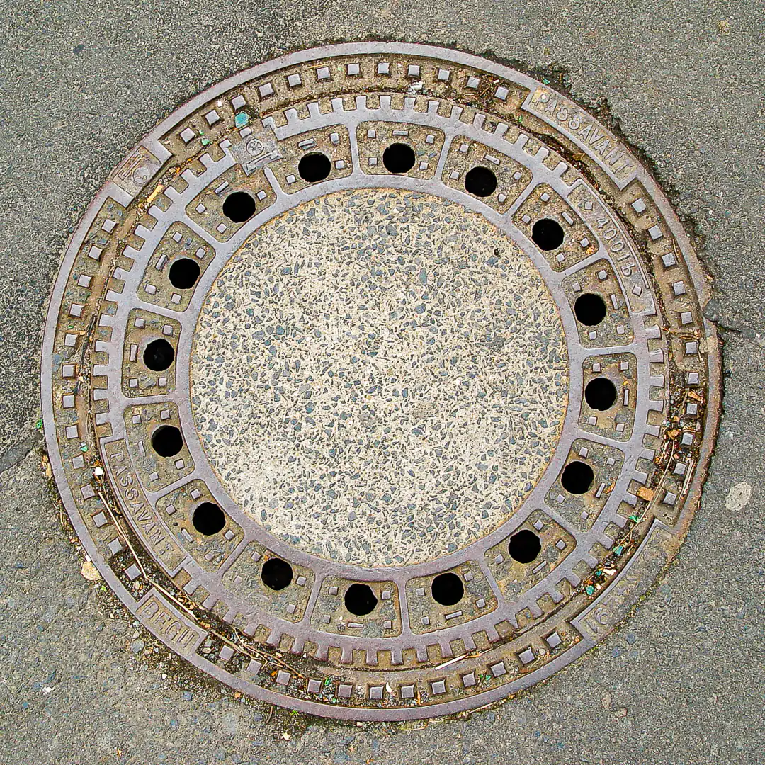 Concrete-filled Manhole Cover with Metal Frame in Marburg, Germany. Photo by Yuri Matrosovich