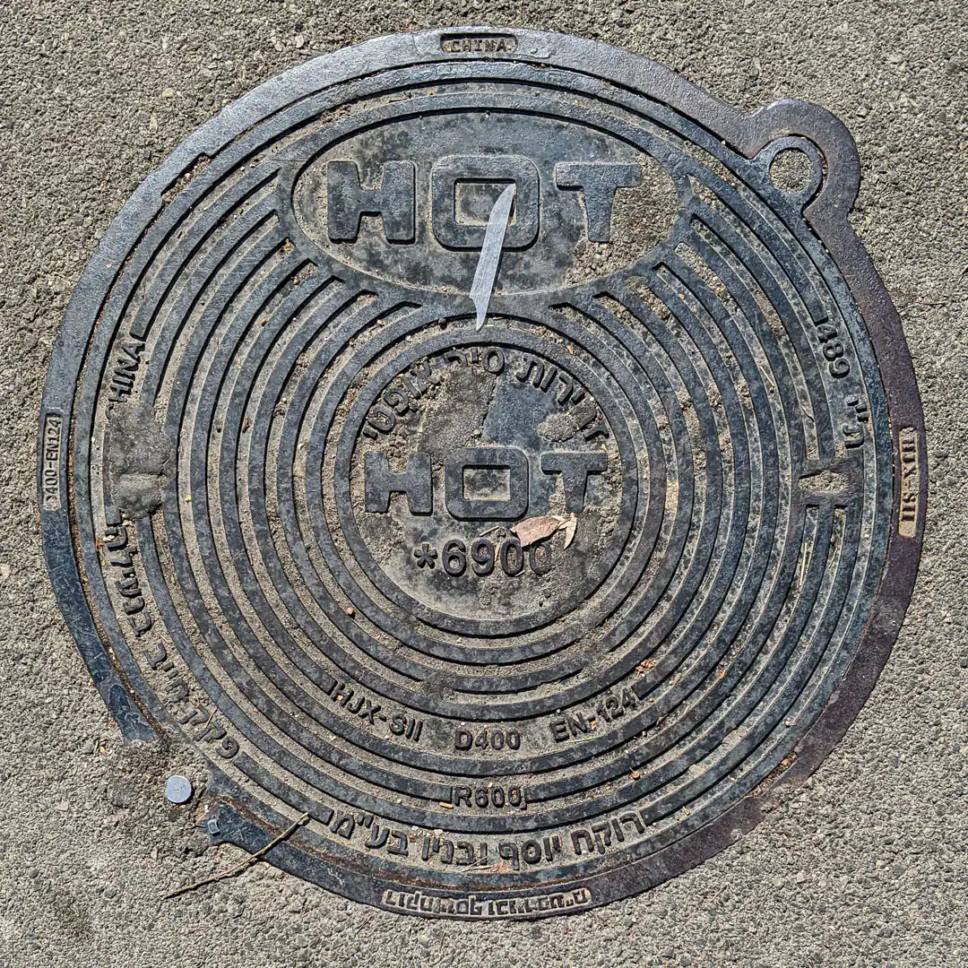 HOT Optical Fibre Manhole Cover in Haifa, Israel. Photo by Yuri Matrosovich