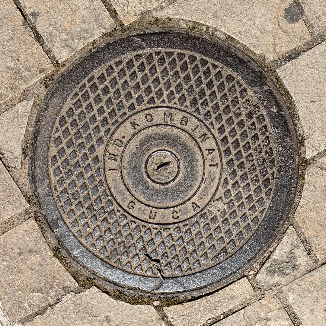 Manhole Cover by Ind. Komb Guča in Budva, Montenegro. Photo by Denis Panin