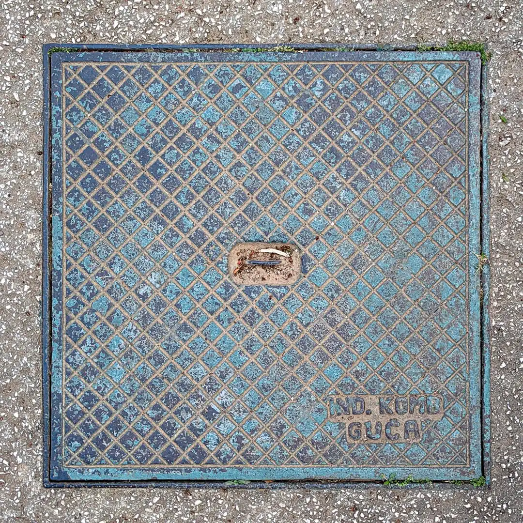 Manhole Cover by Ind. Komb Guča in Budva, Montenegro. Photo by Denis Panin