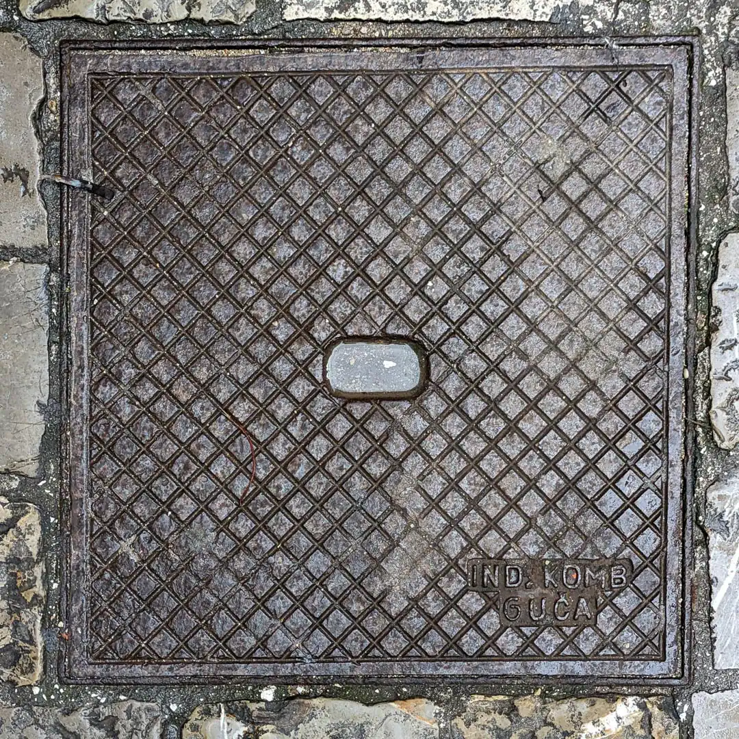 Manhole Cover by Ind. Komb Guča in Budva, Montenegro. Photo by Denis Panin
