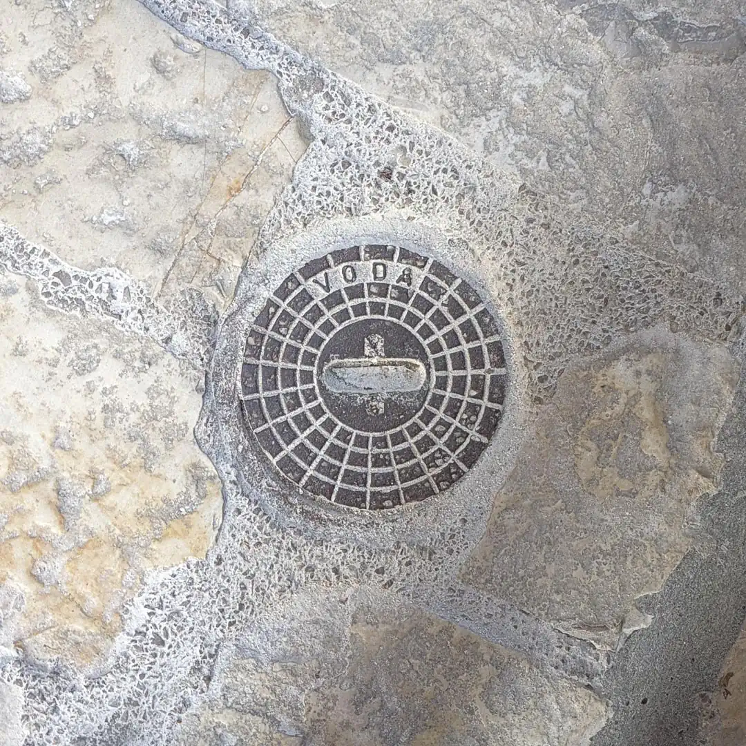 Water Manhole Cover in Budva, Montenegro. Photo by Denis Panin